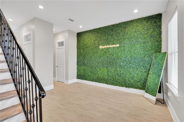 4228 Erato St, New Orleans, LA 70125 - stairway featuring recessed lighting, visible vents, baseboards, an accent wall, and wood finished floors