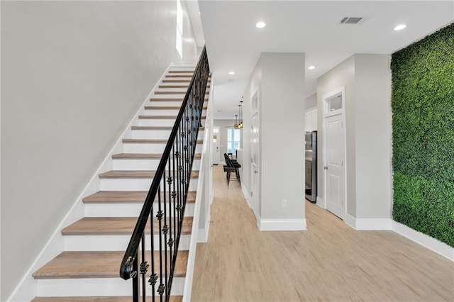 4228 Erato St, New Orleans, LA 70125 - stairway featuring baseboards, visible vents, wood finished floors, and recessed lighting