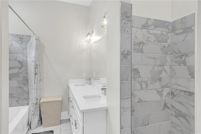 4228 Erato St, New Orleans, LA 70125 - full bath with shower / bath combo, a sink, double vanity, baseboards, and marble finish floor