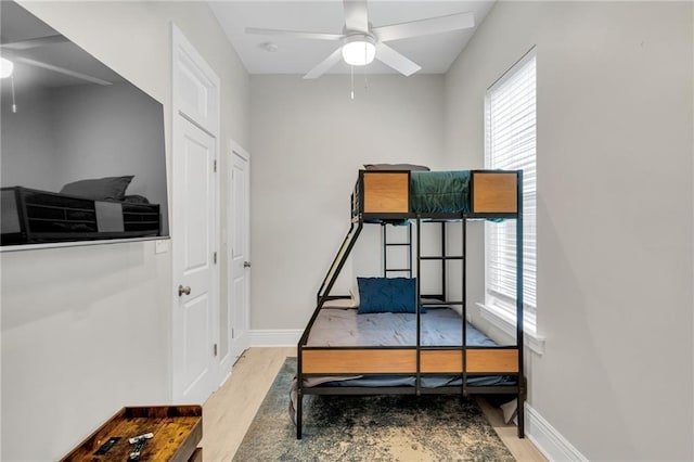4228 Erato St, New Orleans, LA 70125 - bedroom featuring baseboards, wood finished floors, and multiple windows