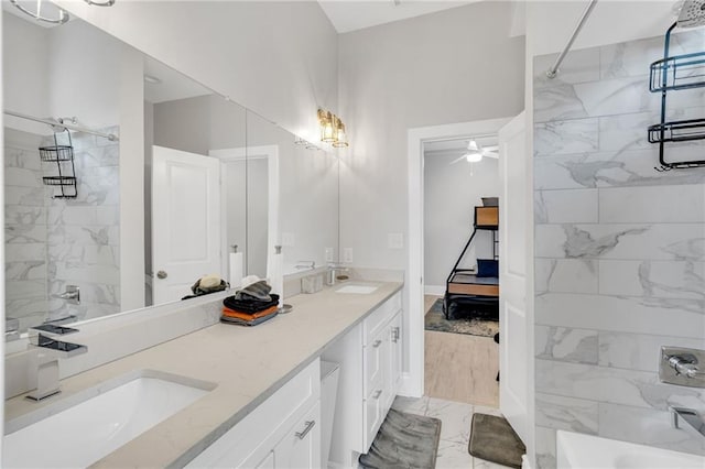 4228 Erato St, New Orleans, LA 70125 - full bathroom featuring double vanity, marble finish floor, ceiling fan, a sink, and a shower