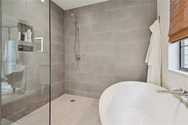 full bath with a soaking tub, walk in shower, and a sink