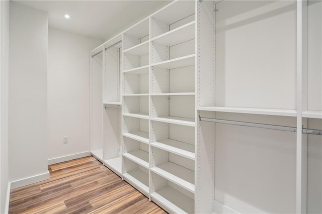 walk in closet featuring wood finished floors