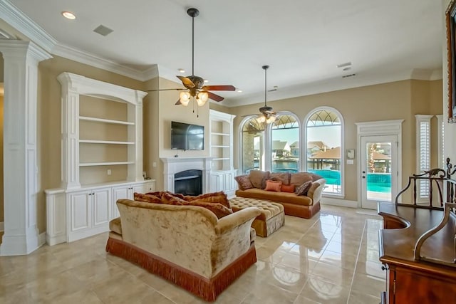 1270 Cutter Cv, Slidell, LA 70458 - living area featuring a fireplace, a ceiling fan, built in features, ornamental molding, and light tile patterned floors
