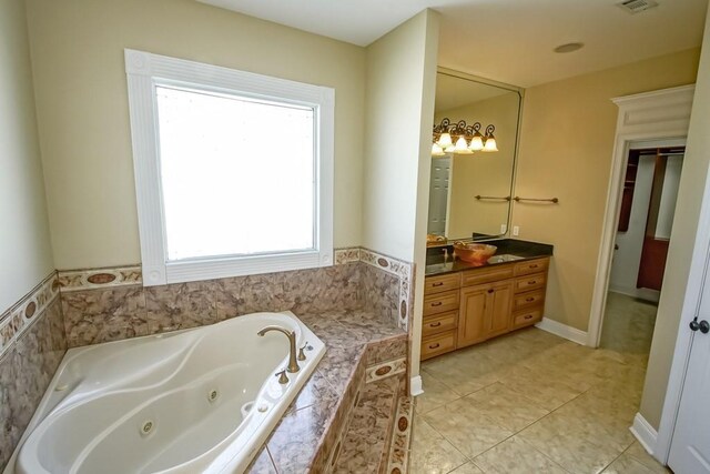 1270 Cutter Cv, Slidell, LA 70458 - full bath featuring vanity, a jetted tub, and tile patterned flooring