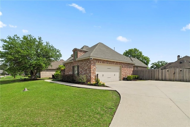 274 W Longview Ct, Madisonville, LA 70447 - view of property exterior featuring a garage, a yard, fence, concrete driveway, and brick siding
