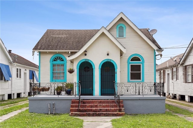 view of front of home with a porch and a shingled roof