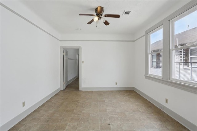 spare room with visible vents and a ceiling fan