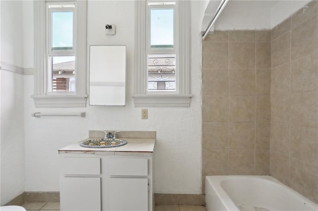 bathroom featuring tile patterned floors, vanity, and plenty of natural light