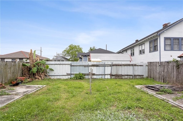 view of yard with a fenced backyard