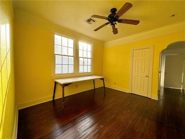 spare room featuring visible vents, ceiling fan, hardwood / wood-style floors, and baseboards