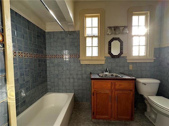 full bathroom featuring tile walls, toilet, tile patterned flooring, and vanity