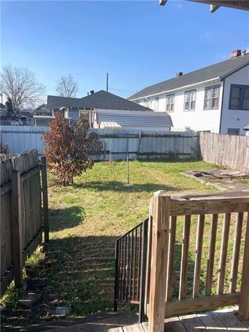 view of yard featuring a deck and a fenced backyard