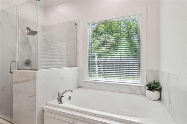bathroom with a garden tub and a stall shower