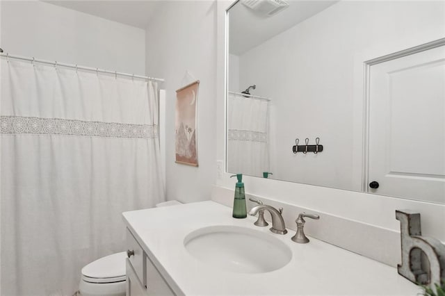 bathroom featuring visible vents, toilet, a shower with shower curtain, and vanity