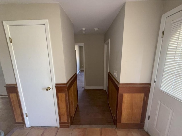 corridor with a wainscoted wall