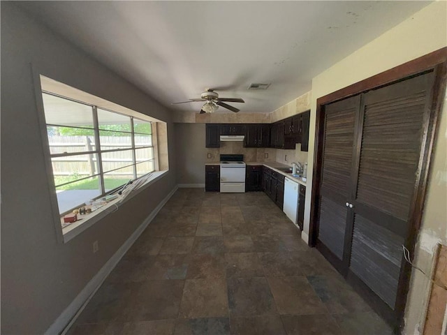kitchen featuring ceiling fan, light countertops, under cabinet range hood, baseboards, and white appliances