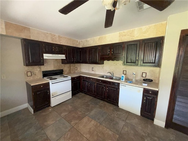 kitchen with white appliances, light countertops, under cabinet range hood, and a sink