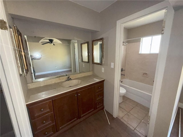 bathroom with a ceiling fan, toilet, shower / bath combination, and vanity