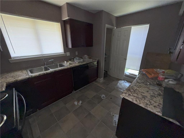 kitchen featuring a sink, light countertops, dark brown cabinetry, black dishwasher, and tile patterned flooring