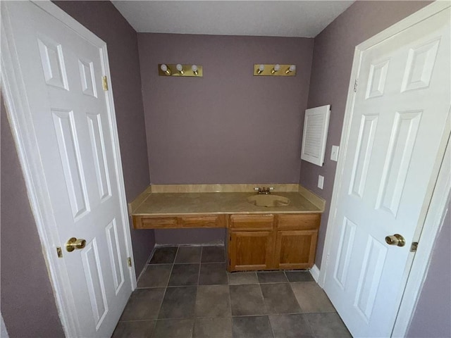 bathroom featuring tile patterned flooring and vanity