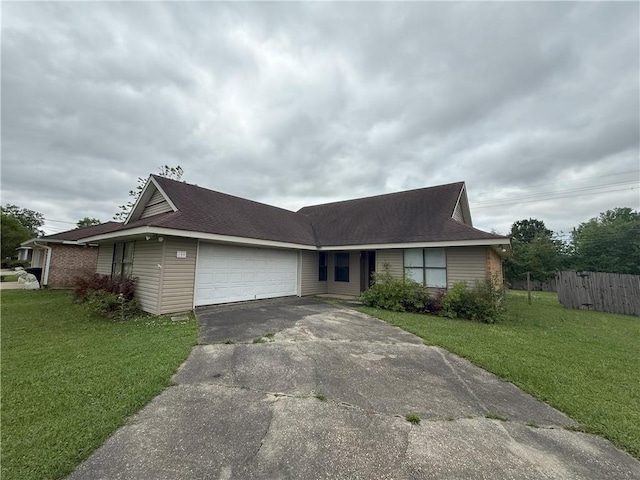 ranch-style house with a front yard, fence, a garage, and aphalt driveway