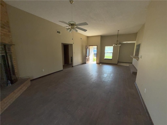 unfurnished living room with baseboards, visible vents, wood finished floors, and a fireplace