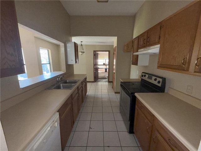 kitchen with under cabinet range hood, brown cabinets, electric range oven, dishwasher, and a sink