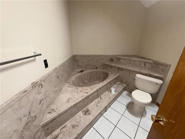 bathroom featuring toilet, a jetted tub, and tile patterned floors