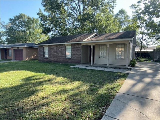 ranch-style house featuring a porch, a front yard, a garage, driveway, and brick siding