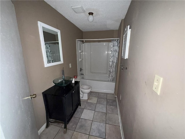 full bathroom with tile patterned flooring, shower / bath combo with shower curtain, toilet, vanity, and a textured ceiling