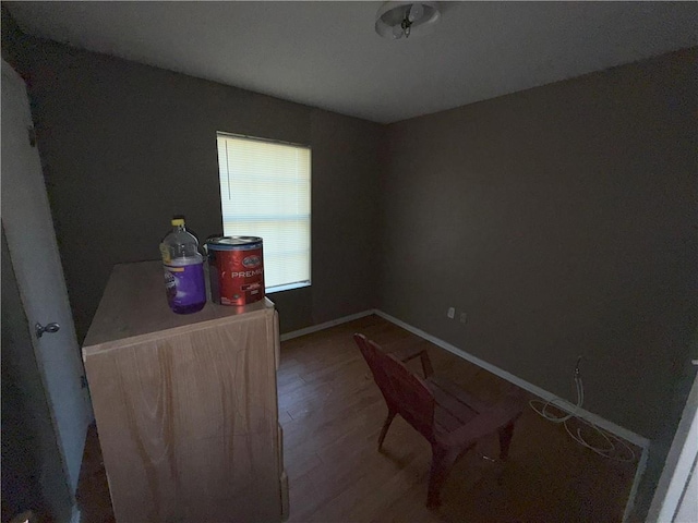 interior space featuring baseboards and wood finished floors