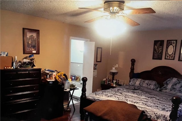 bedroom featuring a textured ceiling and a ceiling fan
