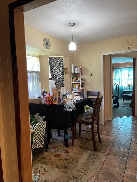 dining space with tile patterned flooring