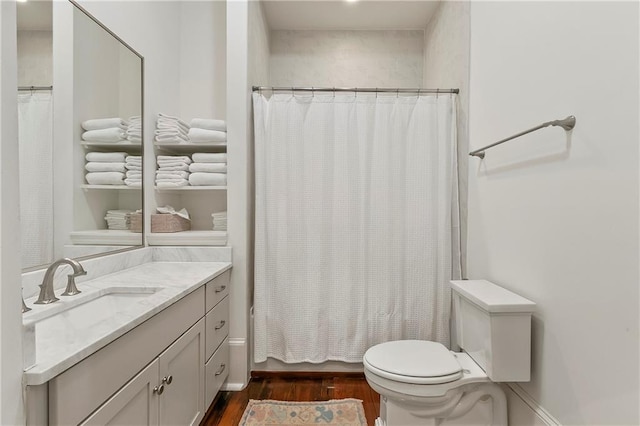 716 Governor Nicholls St Unit C, New Orleans, LA 70116 - bathroom featuring wood finished floors, toilet, vanity, and shower / bath combination with curtain
