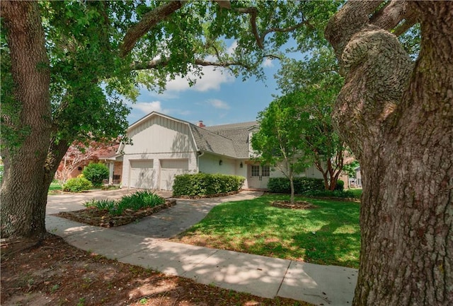 view of front facade featuring a front yard, concrete driveway, a garage, and brick siding