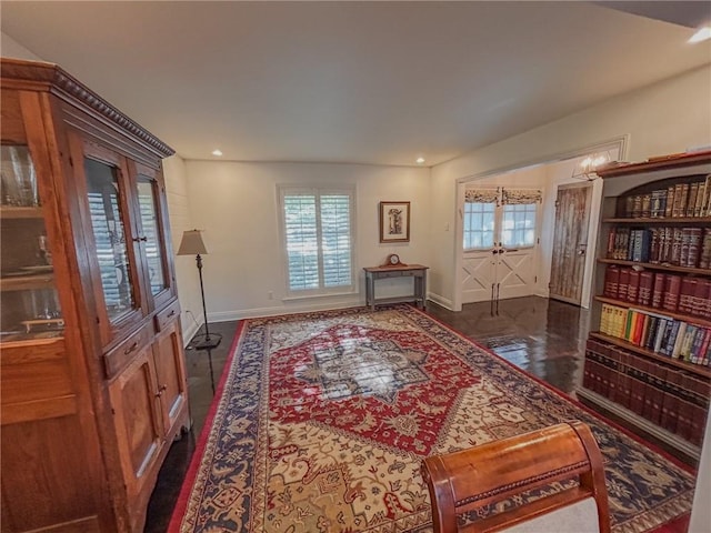 living area with recessed lighting, french doors, and baseboards