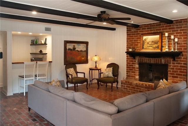 living room with visible vents, brick floor, beam ceiling, and ceiling fan