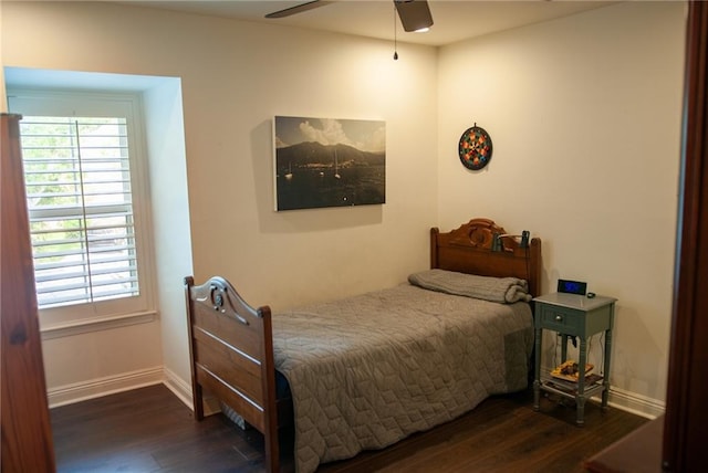 bedroom featuring baseboards, wood finished floors, and ceiling fan