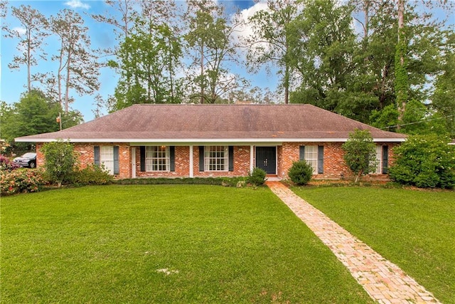 ranch-style home featuring a front lawn, a shingled roof, and brick siding