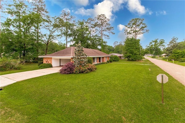 view of side of home featuring driveway, a carport, and a lawn