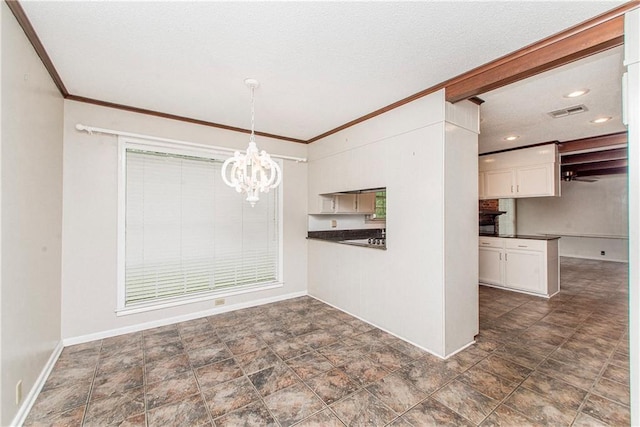 unfurnished dining area with a chandelier, crown molding, visible vents, and baseboards