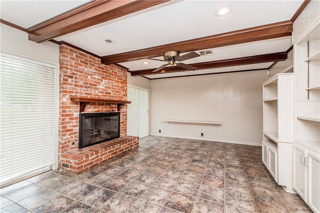 unfurnished living room featuring beamed ceiling, visible vents, baseboards, a fireplace, and a ceiling fan