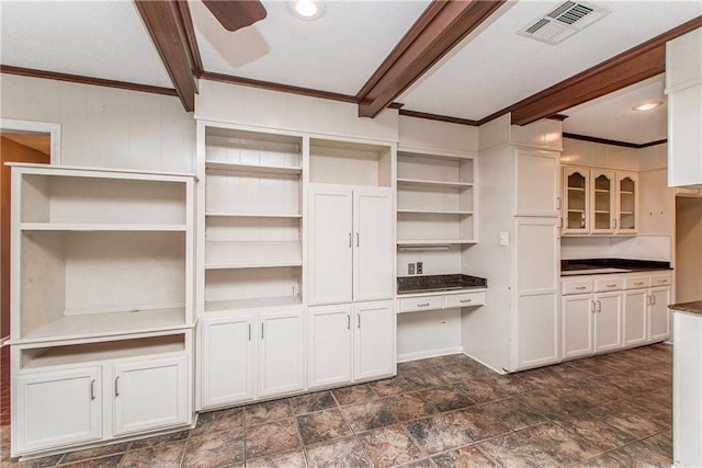 interior space featuring stone finish floor, visible vents, ceiling fan, and beamed ceiling