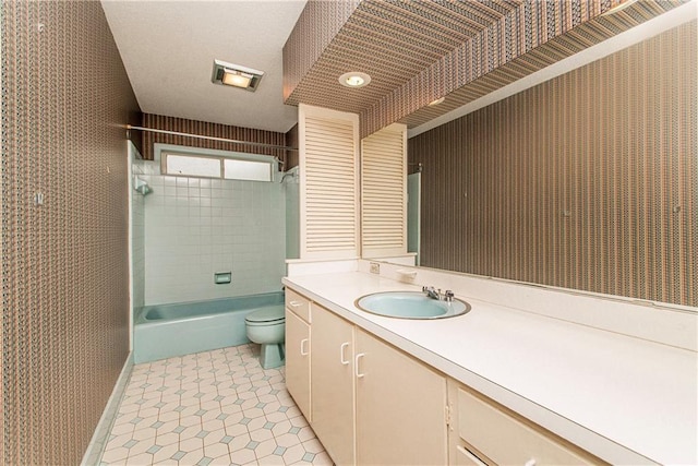 bathroom with toilet, shower / tub combination, wallpapered walls, and vanity