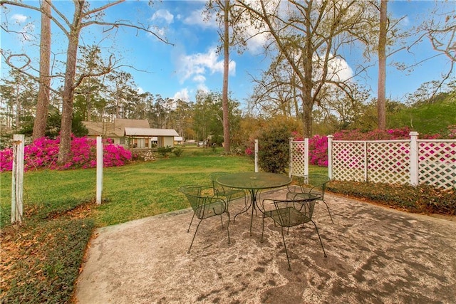 view of patio with outdoor dining space and an outbuilding