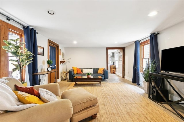 living room with baseboards and recessed lighting