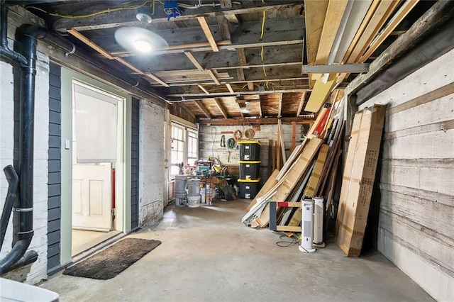 basement featuring wood walls