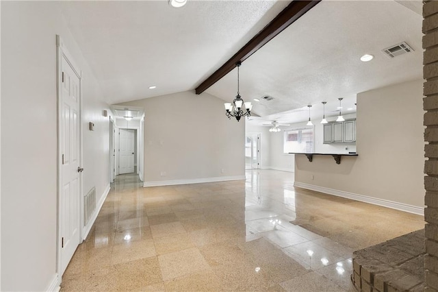 unfurnished living room with visible vents, baseboards, ceiling fan with notable chandelier, and granite finish floor