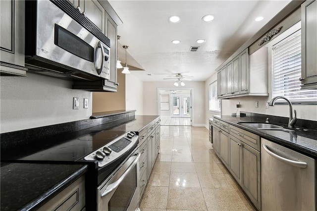 kitchen featuring ceiling fan, appliances with stainless steel finishes, a sink, recessed lighting, and visible vents